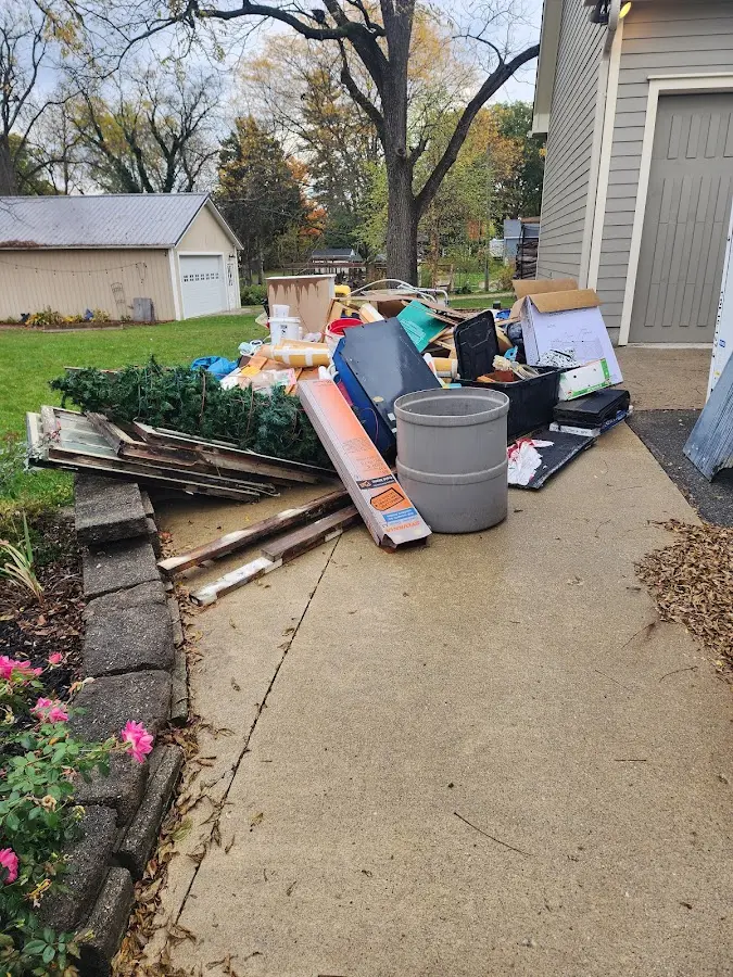 Dumpster being loaded with debris for Estate Cleanout Dumpster Rental in Tequesta